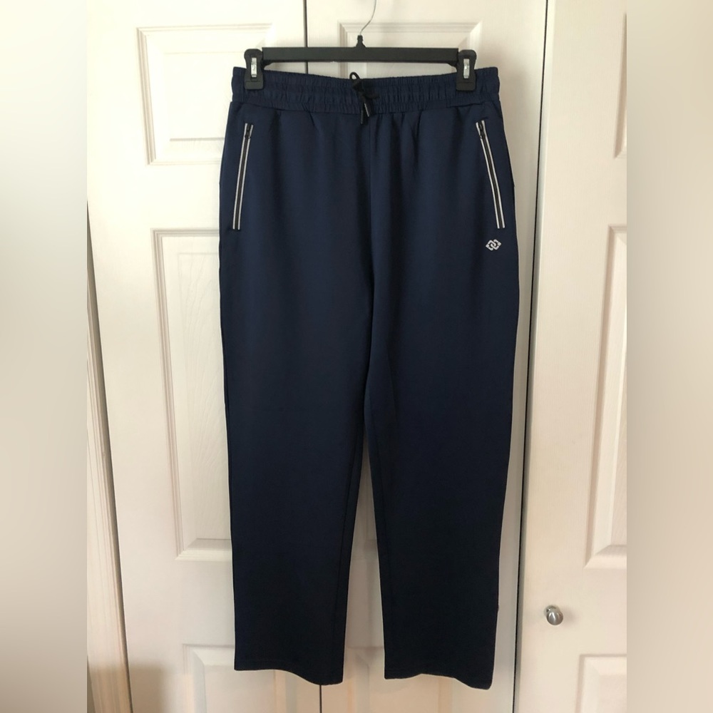 NWOT Navy blue men’s track pants. Reflective trim, Poly/Spandex blend.